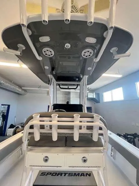 Slide: The Image of 2025 Sportsman 227 MASTERS boat interior with rod holders and speakers. - 8