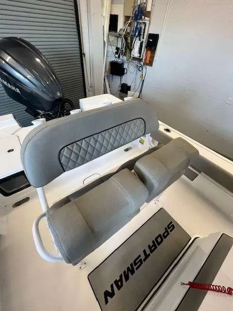 Slide: The Image of 2025 Sportsman 227 MASTERS boat interior with cushioned seating and Yamaha engine. - 9