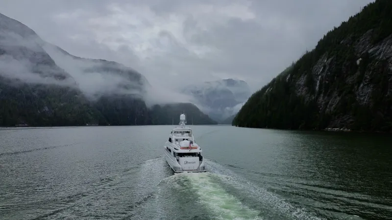 Slide: The Image of Delta Motoryacht 2001 cruising through misty fjord with lush green cliffs. - 11