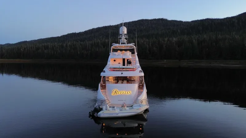 Slide: The Image of Delta Motoryacht 2001 on serene lake with forested backdrop at dusk. - 12