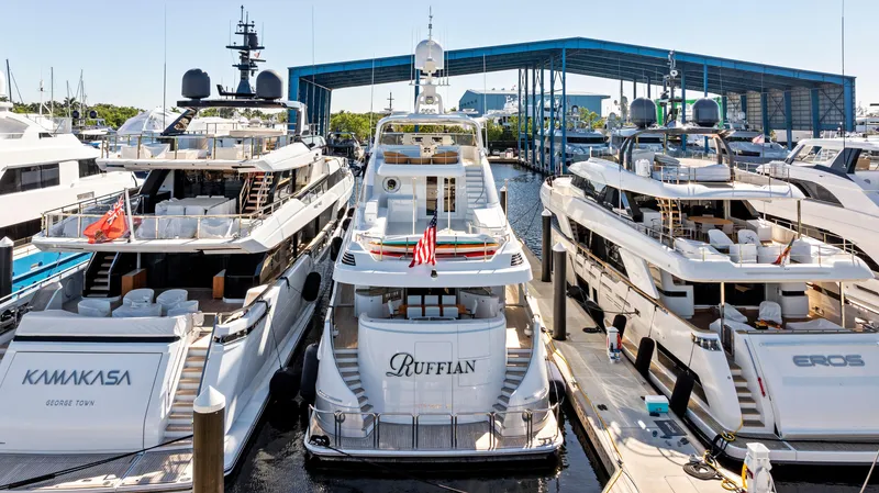 Slide: The Image of Delta 124 Motoryacht 2001 docked among luxury yachts at a marina. - 13