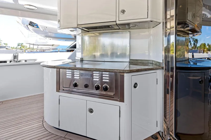 Slide: The Image of Outdoor kitchen on 2001 Delta 124 Motoryacht with stainless steel grill and sleek cabinetry. - 18