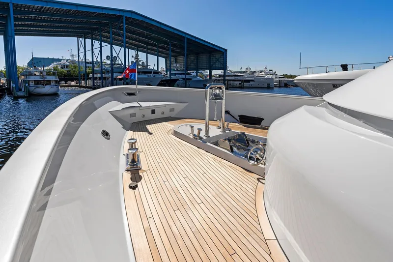 Slide: The Image of Luxurious 2001 Delta 124 Motoryacht with sleek deck design in marina setting. - 21