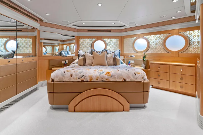 Slide: The Image of Luxurious bedroom on 2001 Delta 124 Motoryacht with elegant decor and circular windows. - 39