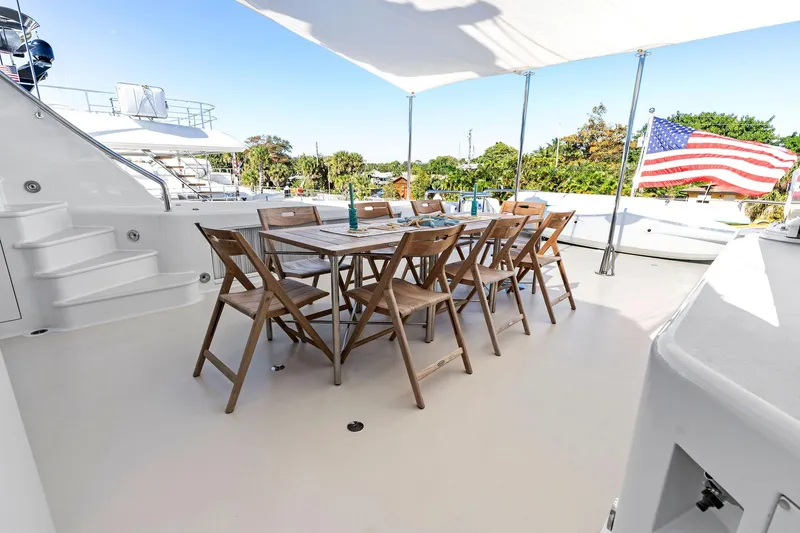 Slide: The Image of Spacious deck of 2001 Delta 124 Motoryacht with dining area and American flag. - 57