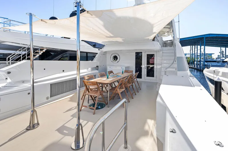 Slide: The Image of Spacious deck of 2001 Delta 124 Motoryacht with dining area and sunshade. - 58