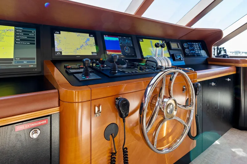 Slide: The Image of Luxurious helm of 2001 Delta 124 Motoryacht with advanced navigation systems. - 61