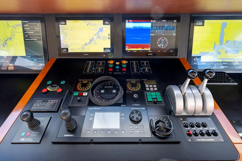 Slide: The Image of Control panel of 2001 Delta 124 Motoryacht with navigation screens and throttle levers. - 63