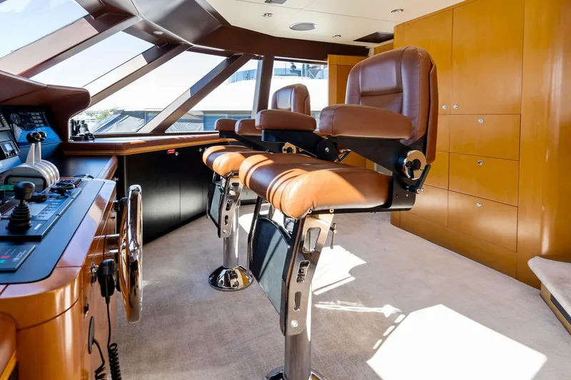 Slide: The Image of Luxurious helm of 2001 Delta 124 Motoryacht with leather seats and modern controls. - 64