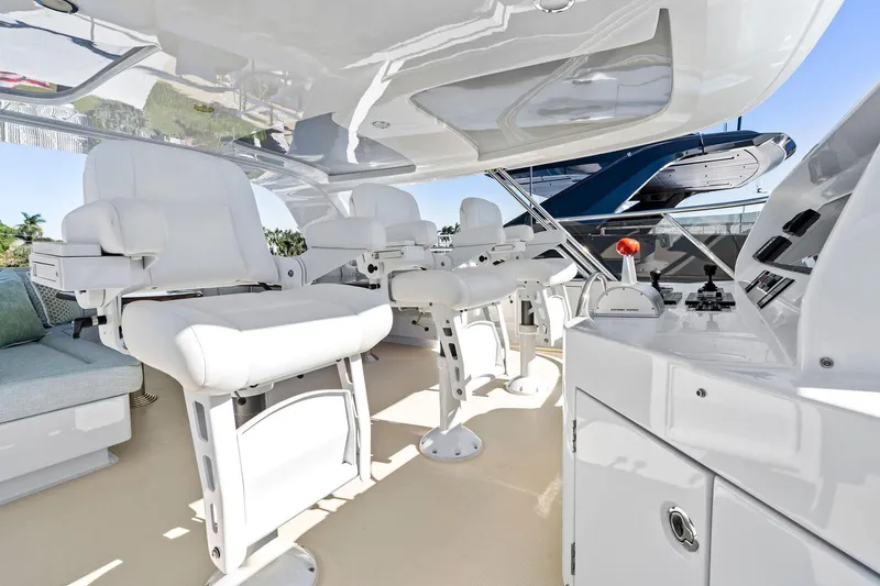 Slide: The Image of Luxurious Delta 124 Motoryacht 2001 helm with plush white seating and modern controls. - 68