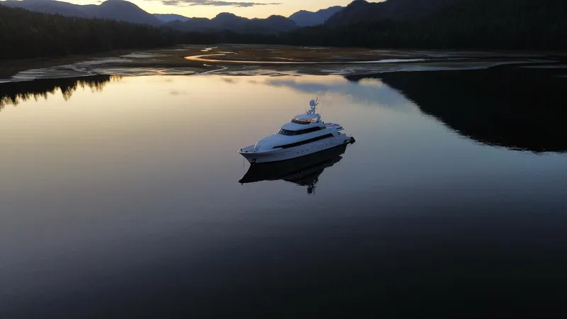 Slide: The Image of Delta Motoryacht 2001 on serene lake at sunset, surrounded by mountains. - 7