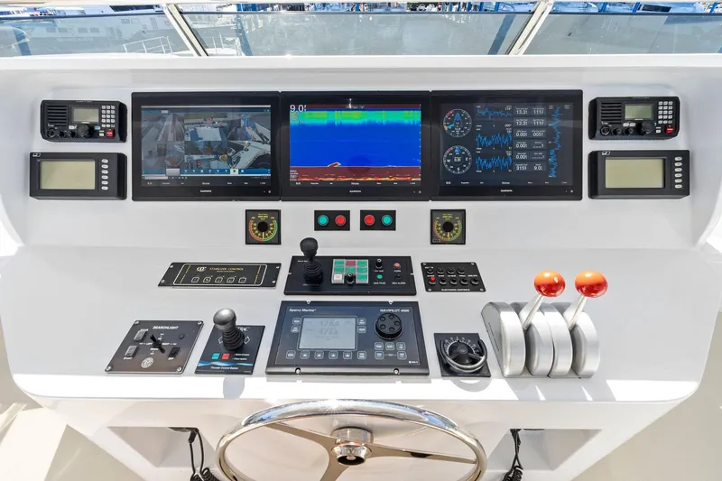Slide: The Image of Control panel of 2001 Delta 124 Motoryacht with navigation screens and throttle levers. - 70