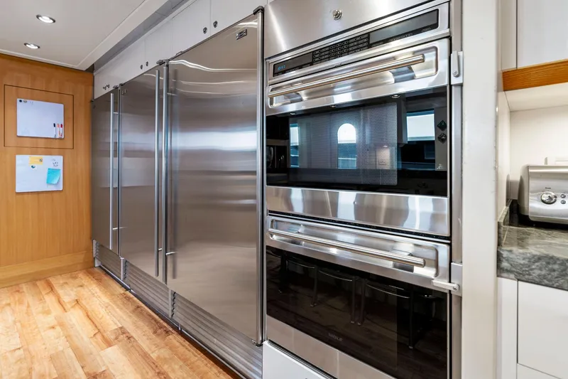 Slide: The Image of Luxurious kitchen appliances on Delta 124 Motoryacht, 2001 model, featuring stainless steel finishes. - 73