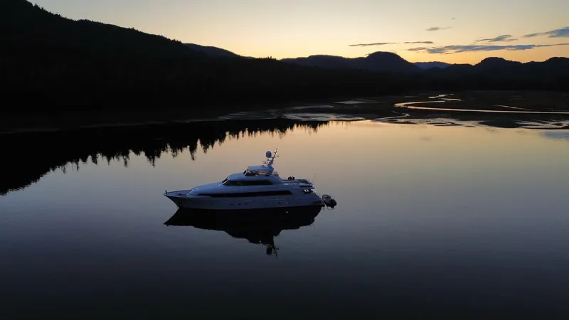 Slide: The Image of Delta Motoryacht 2001 on serene lake at sunset, surrounded by mountains. - 8