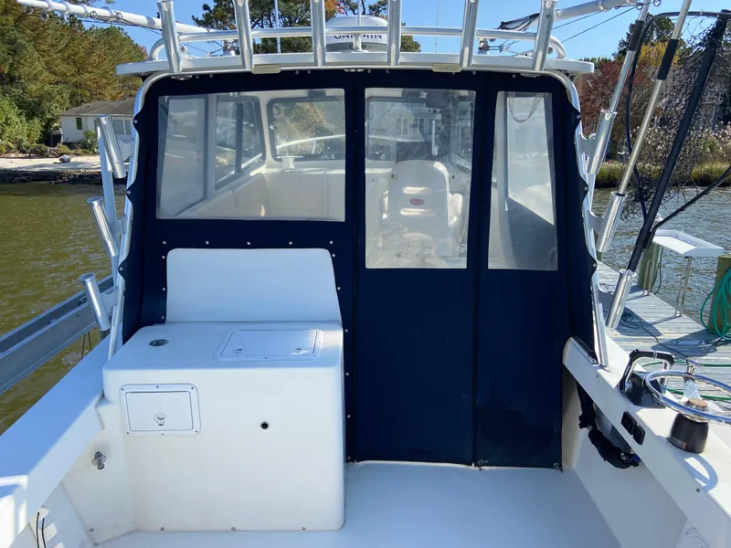 Slide: The Image of 2018 Judge 27 Chesapeake XL boat with enclosed cabin, docked by the water. - 15