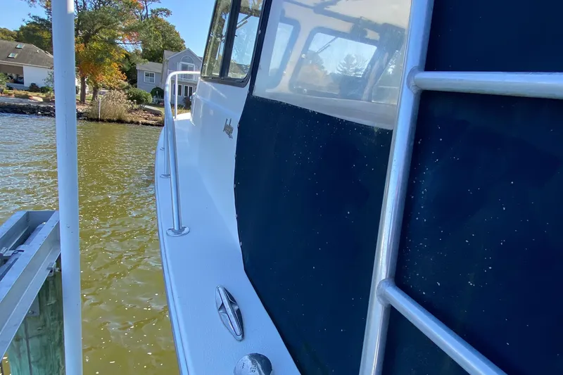 Slide: The Image of 2018 Judge 27 Chesapeake XL boat docked by a lakeside home. - 16