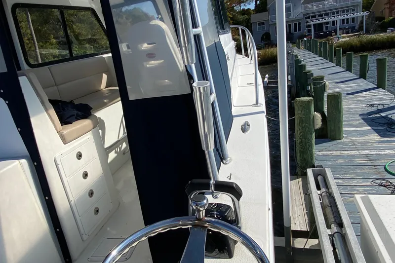 Slide: The Image of 2018 Judge 27 Chesapeake XL boat docked beside wooden pier. - 17