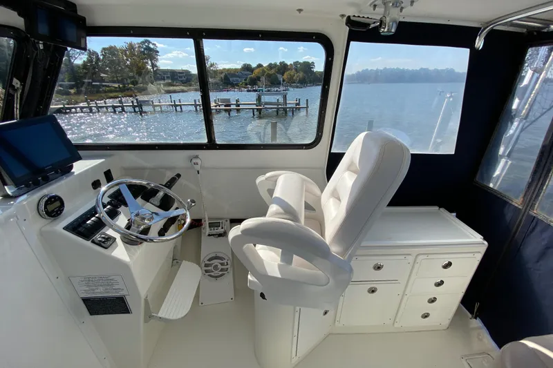 Slide: The Image of Interior of 2018 Judge 27 Chesapeake XL boat with steering wheel and seating. - 22