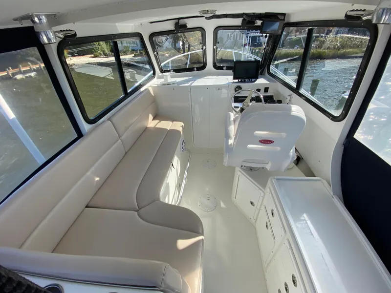 Slide: The Image of Interior of 2018 Judge 27 Chesapeake XL boat with seating and helm. - 24