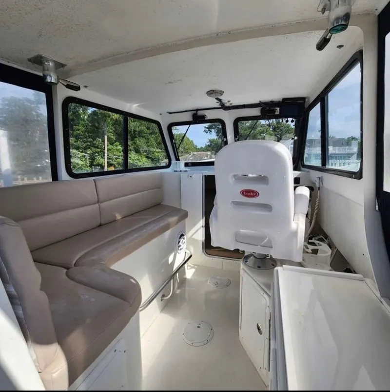 Slide: The Image of Interior of 2018 Judge 27 Chesapeake XL boat with seating and helm. - 25