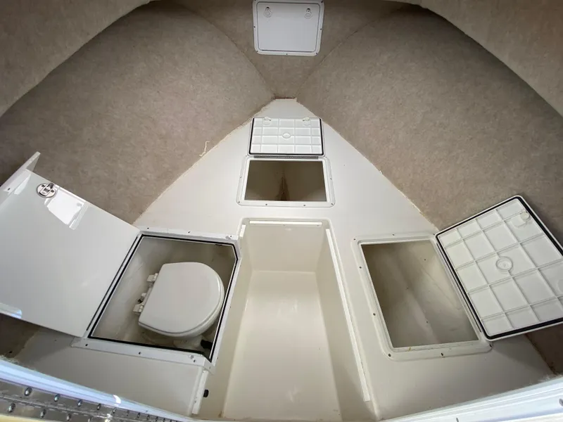 Slide: The Image of 2018 Judge 27 Chesapeake XL boat interior with storage compartments and toilet. - 29