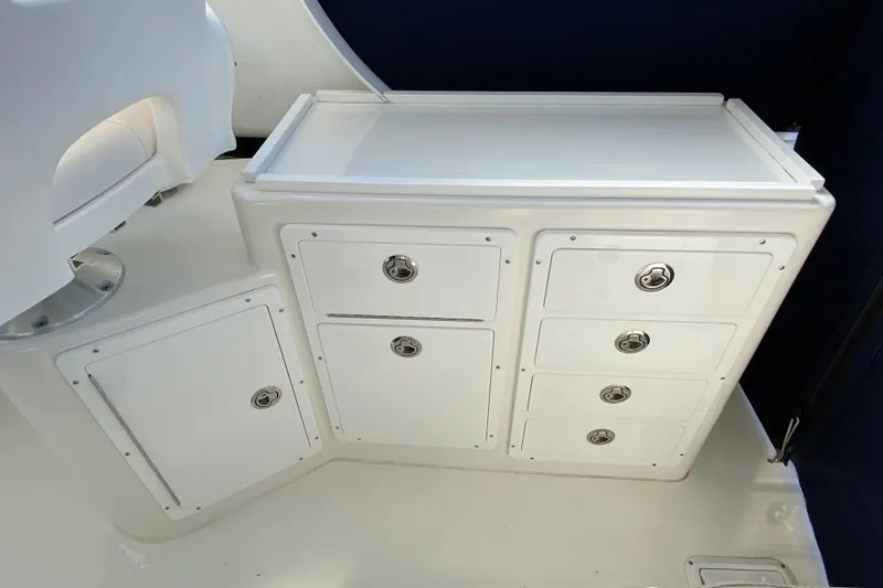Slide: The Image of White storage cabinets on 2018 Judge 27 Chesapeake XL boat interior. - 30