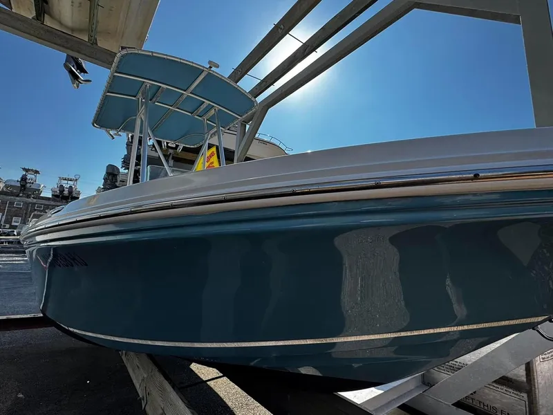 The Image of 2014 Sailfish 1900 BB Bay Boat on trailer under clear blue sky. - 0