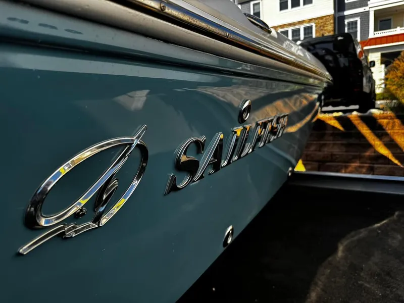 Slide: The Image of 2014 Sailfish 1900 BB Bay Boat, sleek design, parked outdoors. - 3