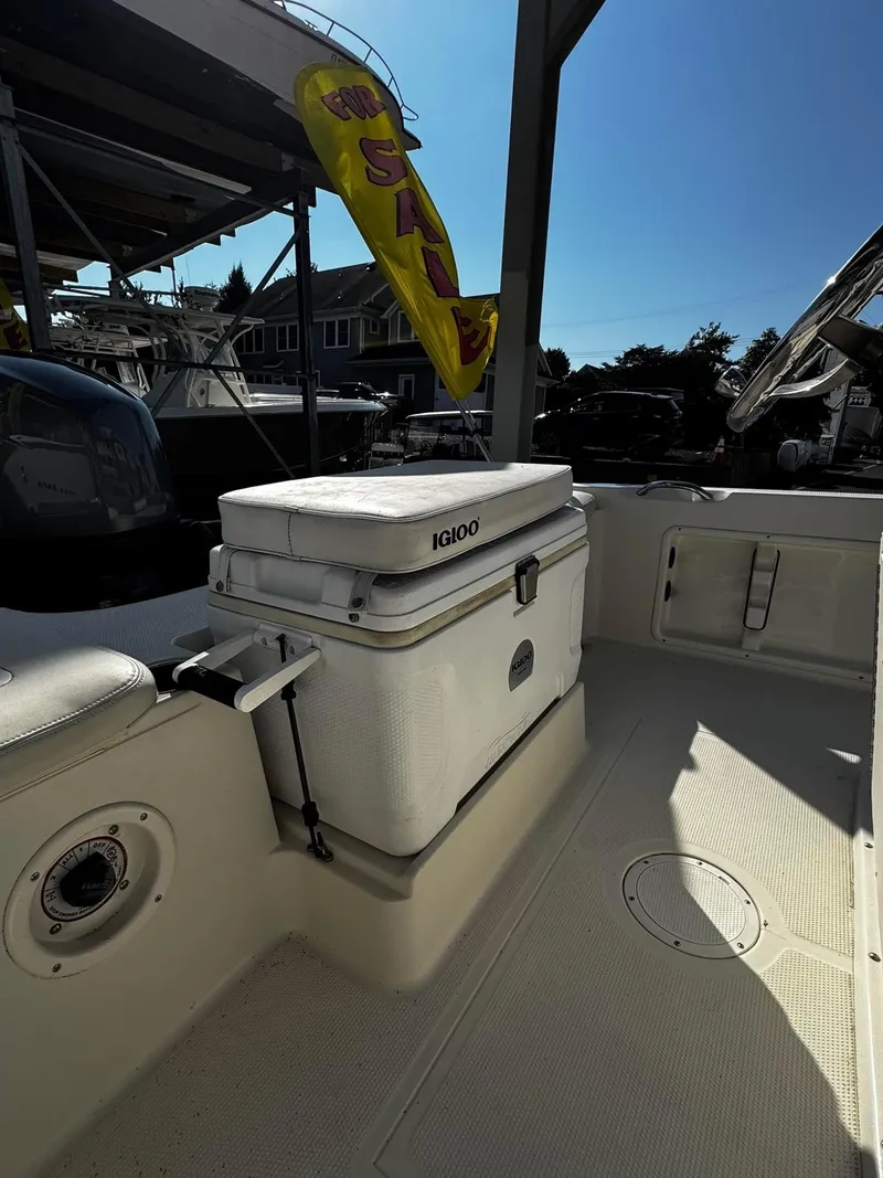 Slide: The Image of 2014 Sailfish 1900 BB Bay Boat deck with Igloo cooler and sale banner. - 5