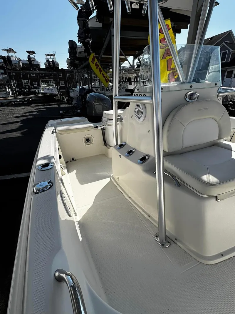 Slide: The Image of 2014 Sailfish 1900 BB Bay Boat with seating and console, docked in a marina. - 6