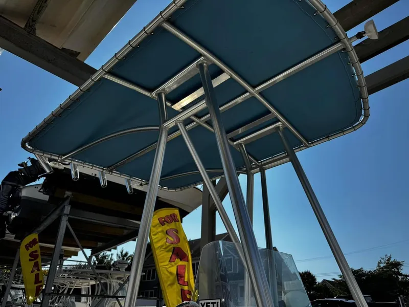 Slide: The Image of 2014 Sailfish 1900 BB Bay Boat for sale with blue canopy. - 8