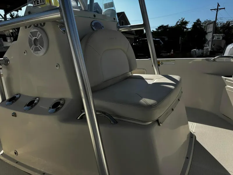 Slide: The Image of 2014 Sailfish 1900 BB Bay Boat interior with cushioned seating and console. - 9