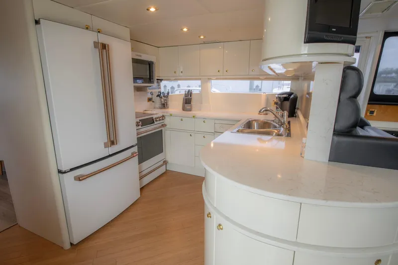 Slide: The Image of Luxurious dining area inside a 1997 Lazzara 76 Motor Yacht with elegant furnishings. - 15