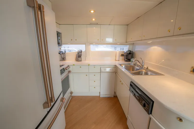 Slide: The Image of Modern kitchen interior on 1997 Lazzara 76 Motor Yacht with white cabinetry and appliances. - 16