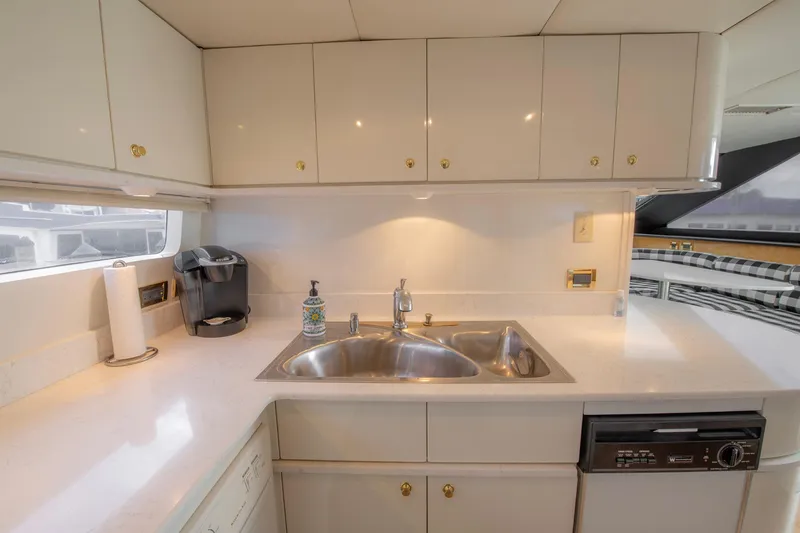 Slide: The Image of Luxurious kitchen and dining area in a 1997 Lazzara 76 Motor Yacht. - 18