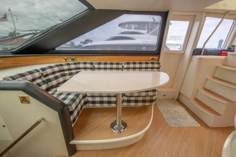 Slide: The Image of Interior of 1997 Lazzara 76 Motor Yacht with checkered seating and modern helm. - 22