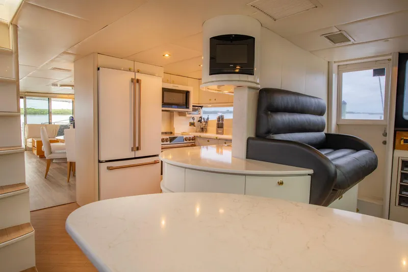 Slide: The Image of Interior of 1997 Lazzara 76 Motor Yacht with checkered seating and table. - 23