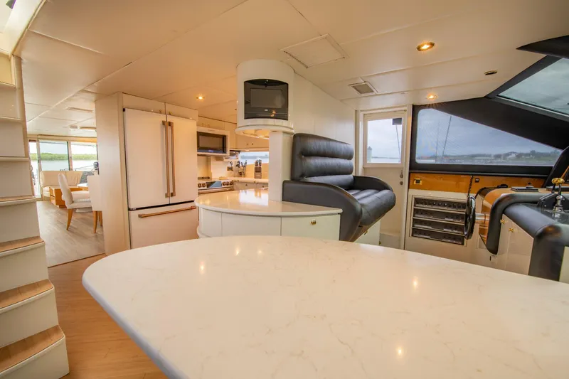 Slide: The Image of Luxurious interior of 1997 Lazzara 76 Motor Yacht with modern kitchen and seating area. - 24