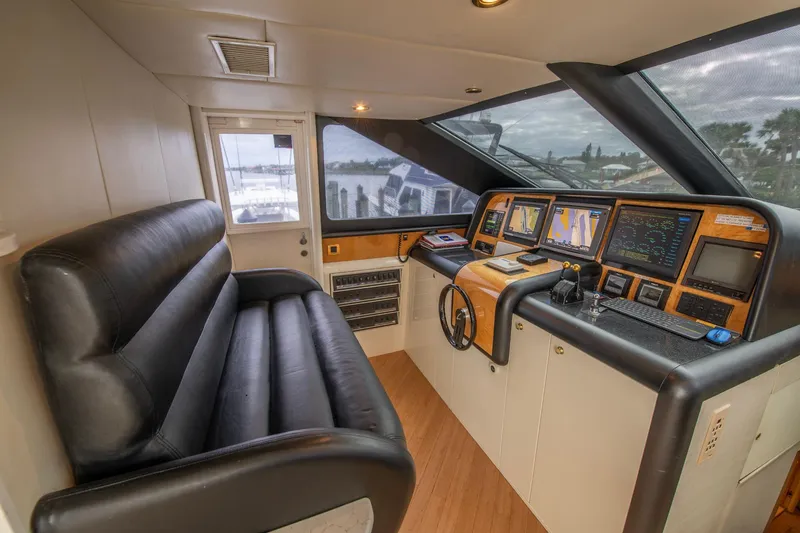 Slide: The Image of Interior of 1997 Lazzara 76 Motor Yacht helm with leather seating and navigation equipment. - 26