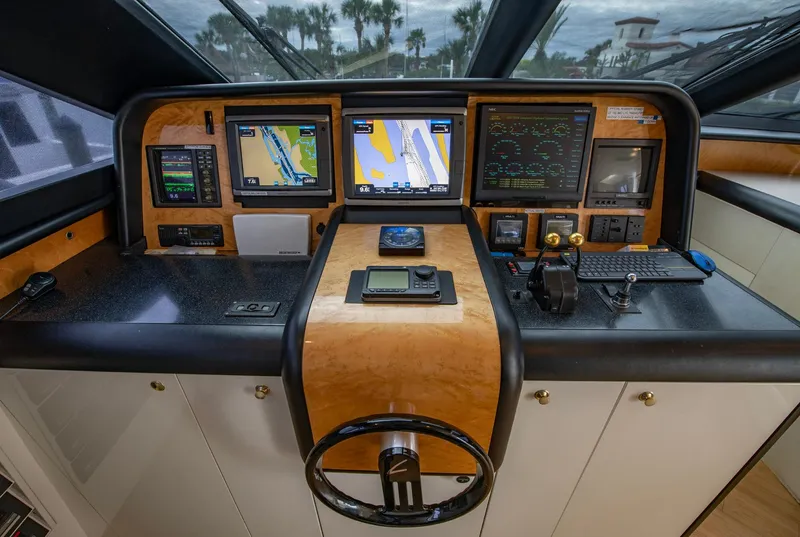 Slide: The Image of 1997 Lazzara 76 Motor Yacht helm with navigation instruments and steering wheel. - 28