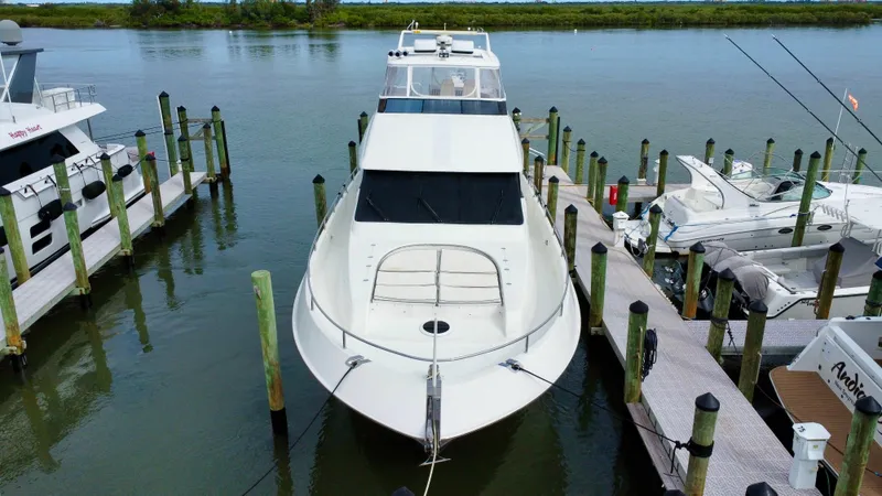 Slide: The Image of Luxury 1997 Lazzara 76 yacht docked at marina, sleek white design. - 3