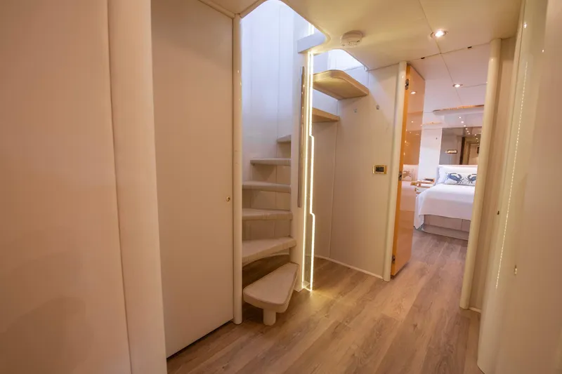 Slide: The Image of Interior of 1997 Lazzara 76 Motor Yacht with elegant staircase and window view. - 31