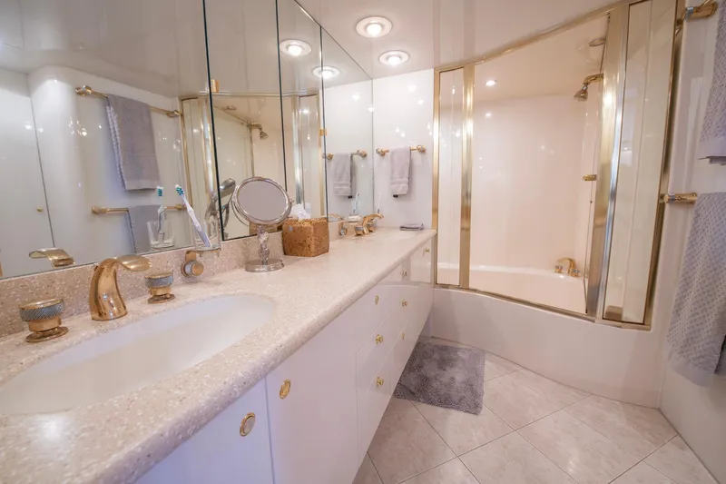 Slide: The Image of Luxurious bathroom in 1997 Lazzara 76 Motor Yacht with gold fixtures and spacious shower. - 40