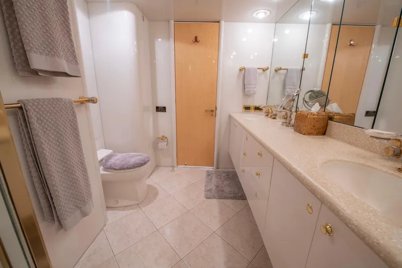 Slide: The Image of Luxurious bathroom in a 1997 Lazzara 76 Motor Yacht with elegant fixtures and ample storage. - 42