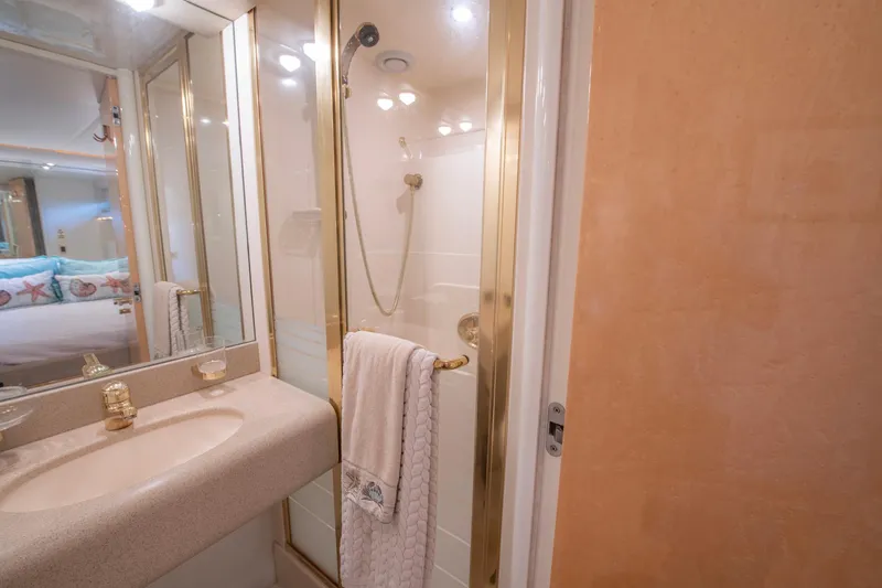 Slide: The Image of Luxurious bathroom in 1997 Lazzara 76 Motor Yacht with gold accents and modern fixtures. - 50