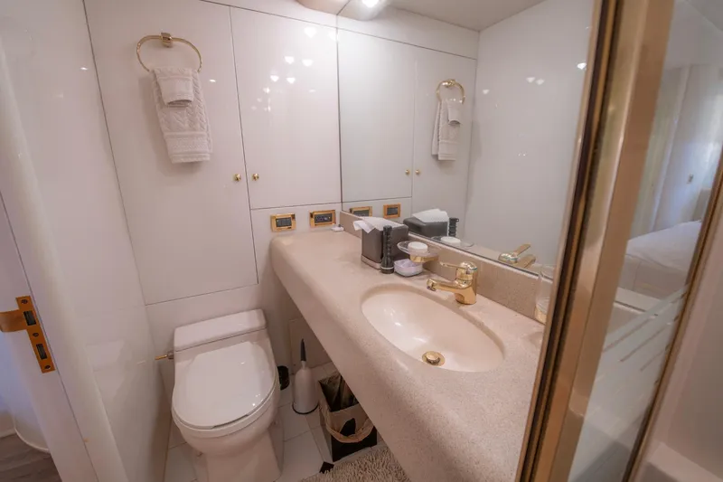 Slide: The Image of Luxurious bathroom in a 1997 Lazzara 76 Motor Yacht with elegant fixtures and ample storage. - 51