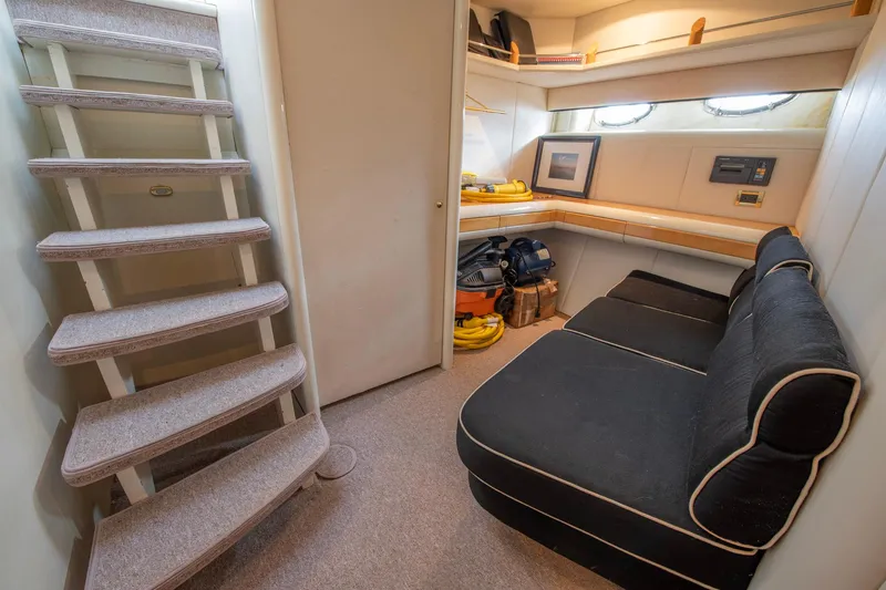 Slide: The Image of Interior of 1997 Lazzara 76 Motor Yacht with stairs, seating, and storage. - 52