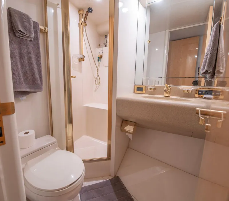 Slide: The Image of Luxurious bathroom in 1997 Lazzara 76 Motor Yacht with gold accents and modern fixtures. - 54