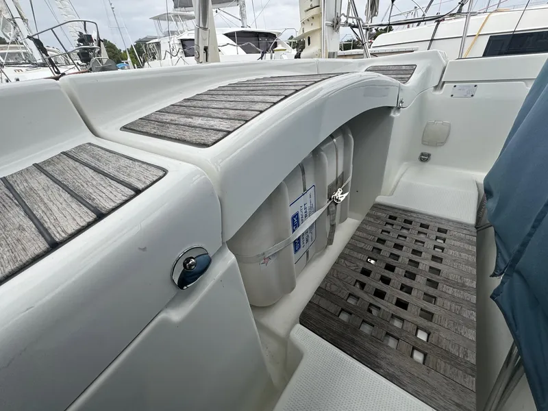 Slide: The Image of Beneteau First 47.7 yacht cockpit, 2004 model, featuring teak decking and storage compartments. - 13
