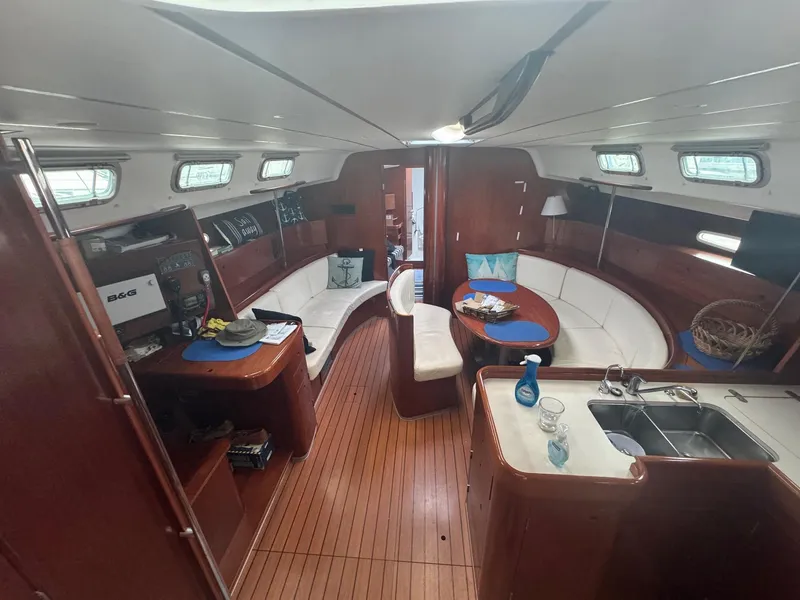 Slide: The Image of Interior of 2004 Beneteau First 47.7 yacht with wood finish and seating area. - 18